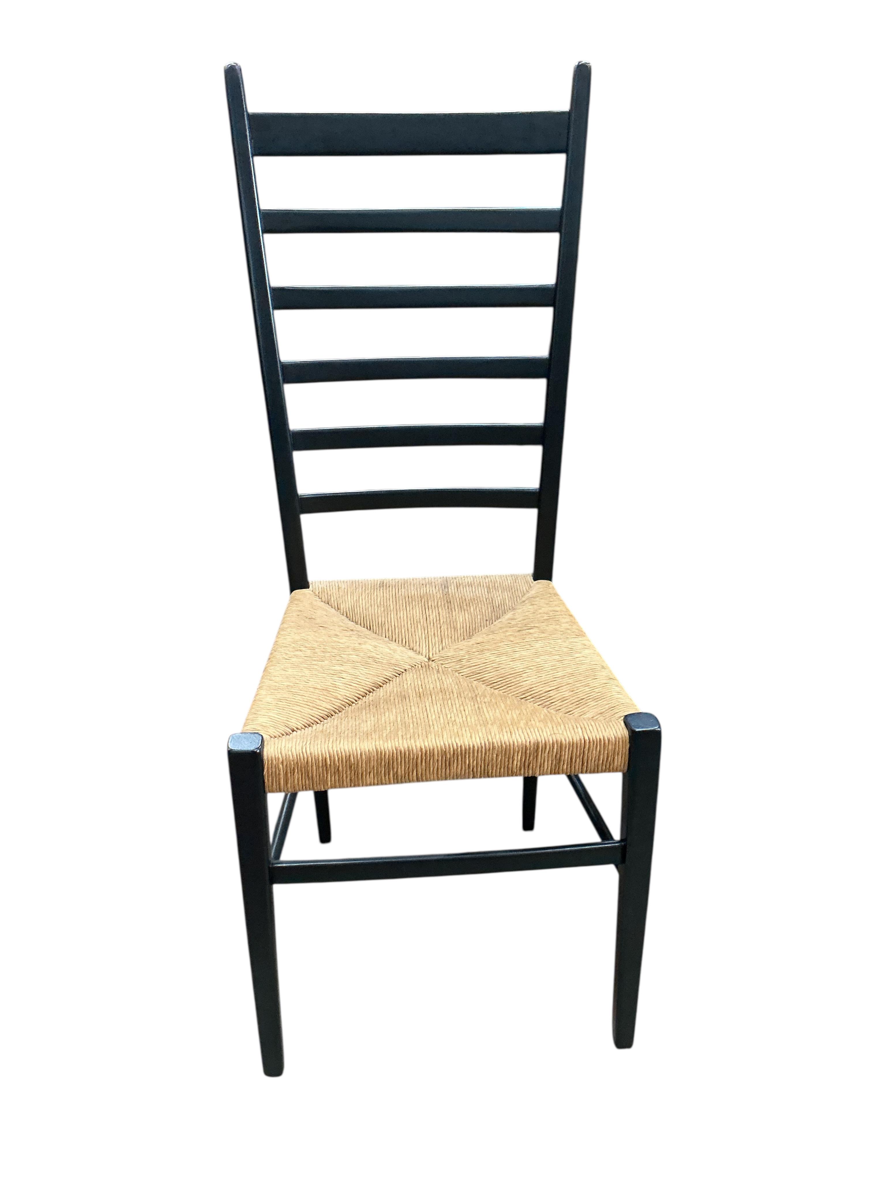 A set of four Gio Ponti ebonised ladderback rush seat dining chairs, width 40cm, depth 41cm, height 107cm
